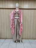grey embroidered outfit on mannequin against striped