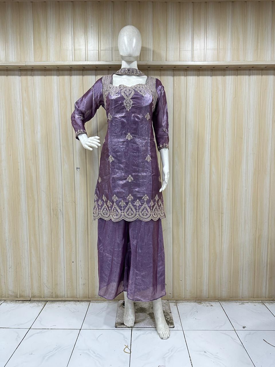 dark purple embroidered outfit on mannequin against striped