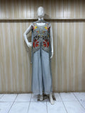 grey embroidered outfit on mannequin against striped