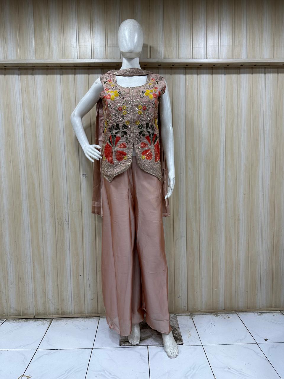 beige embroidered outfit on mannequin against striped