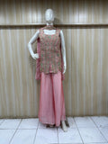 Mannequin wearing a pink traditional outfit with intricate detailing against a striped