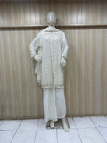 white embroidered traditional outfit on a mannequin against a striped