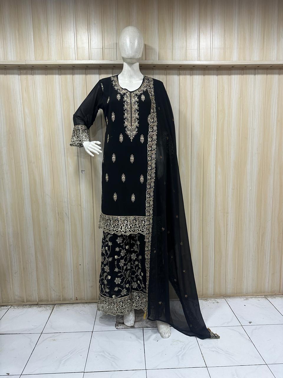 black embroidered traditional outfit on a mannequin against a striped