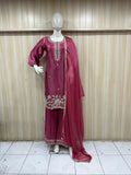 dark pink embroidered traditional outfit on a mannequin against a striped