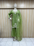 Green embroidered outfit on a mannequin against a striped