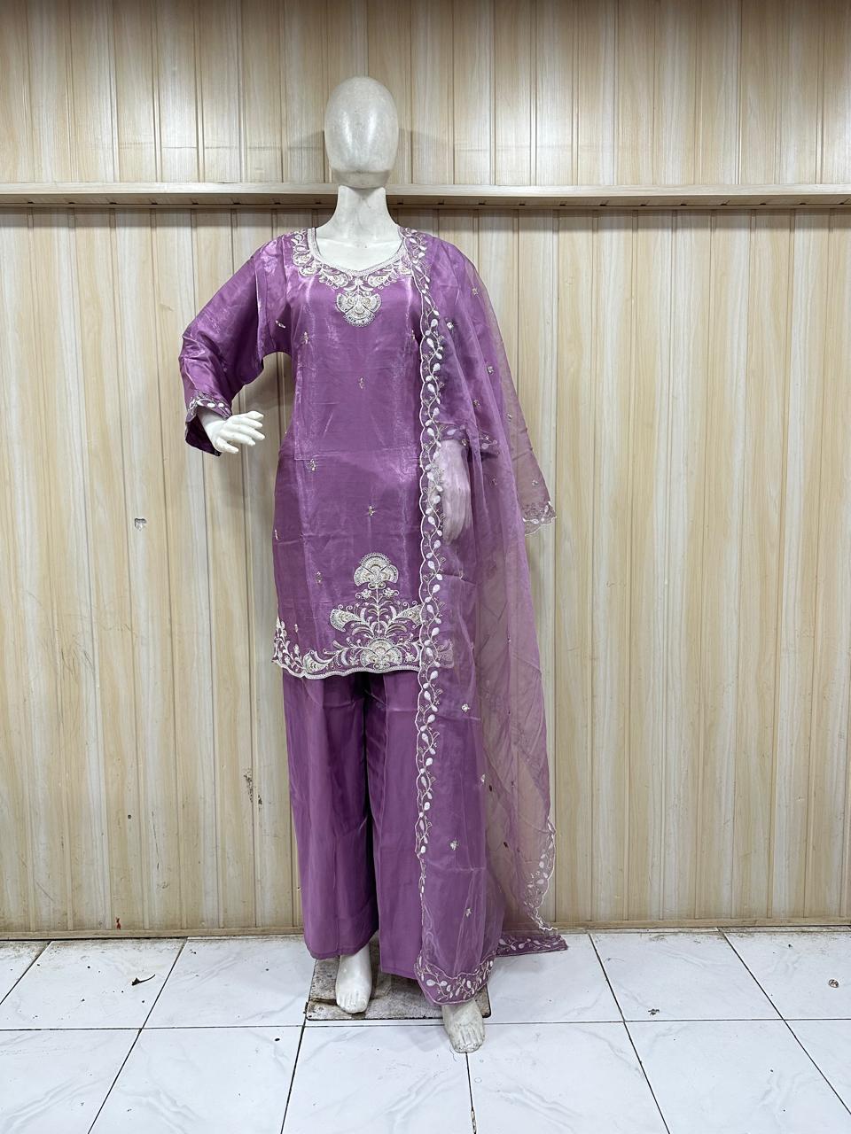 purple traditional outfit with matching dupatta on a mannequin against a striped