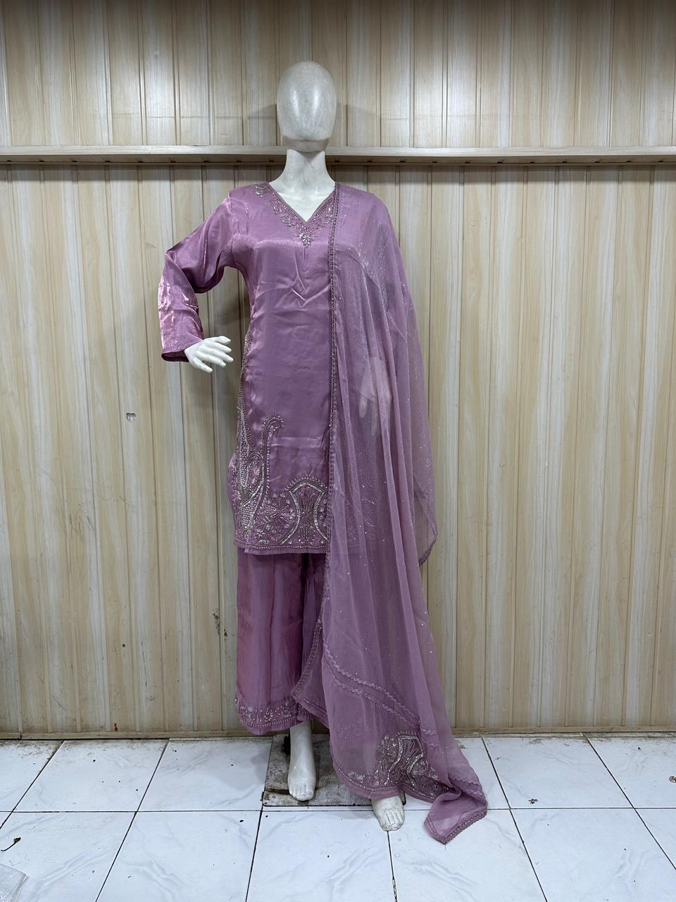 purple traditional outfit with matching dupatta on a mannequin against a striped