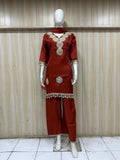 oreang and white traditional outfit with matching dupatta on a mannequin against a striped