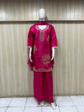 dark pink traditional outfit with matching dupatta on a mannequin against a striped