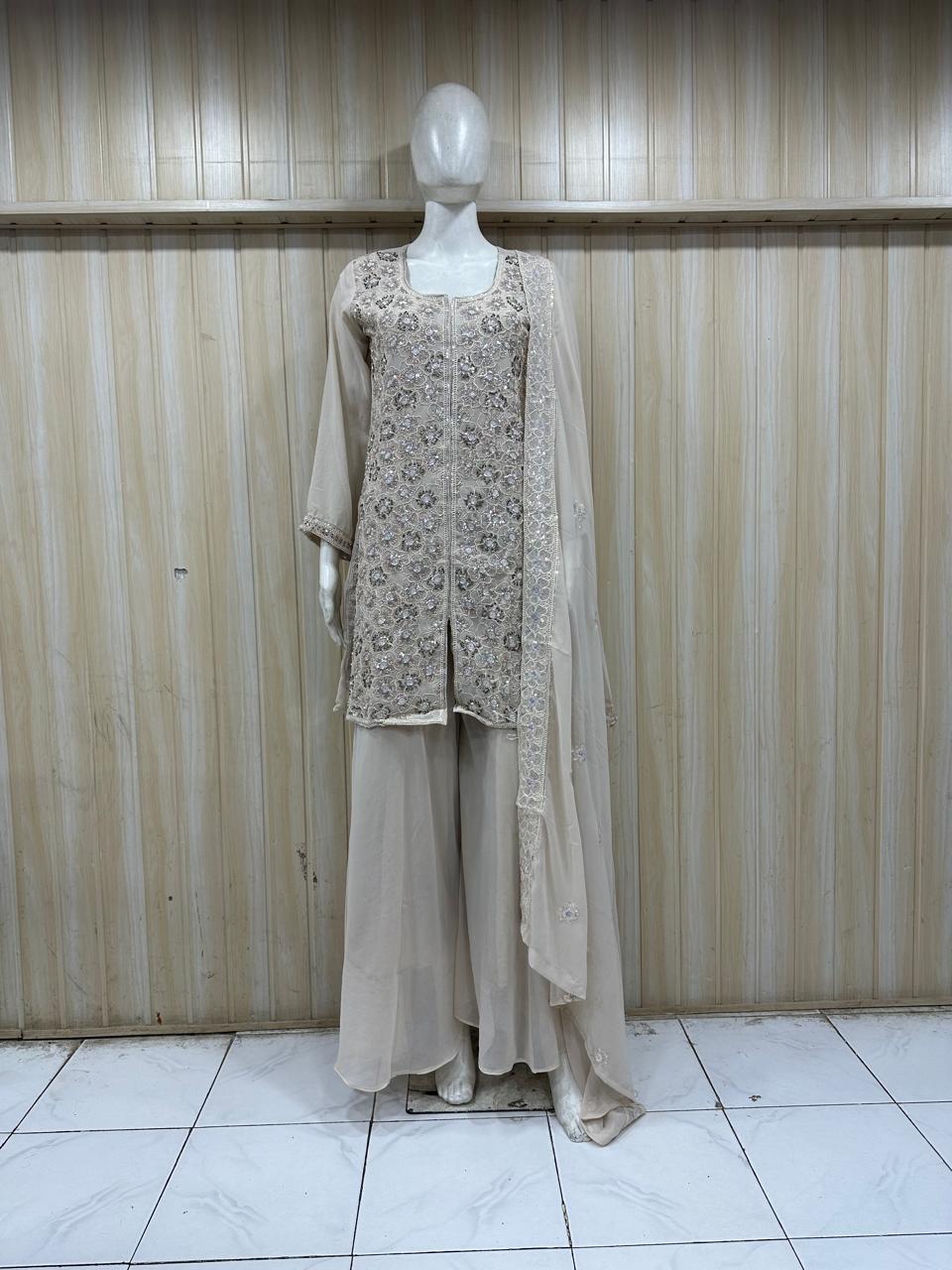 silver traditional outfit with matching dupatta on a mannequin against a striped