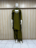 green traditional outfit with matching dupatta on a mannequin against a striped