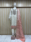 white and pink traditional outfit with matching dupatta on a mannequin against a striped