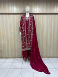 red traditional outfit with matching dupatta on a mannequin against a striped