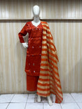 orange traditional outfit with matching dupatta on a mannequin against a striped