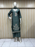 dark  traditional outfit with matching dupatta on a mannequin against a striped