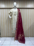 white pink traditional outfit with matching dupatta on a mannequin against a striped