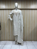 white traditional outfit with matching dupatta on a mannequin against a striped