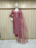 rose gold traditional outfit with matching dupatta on a mannequin against a striped