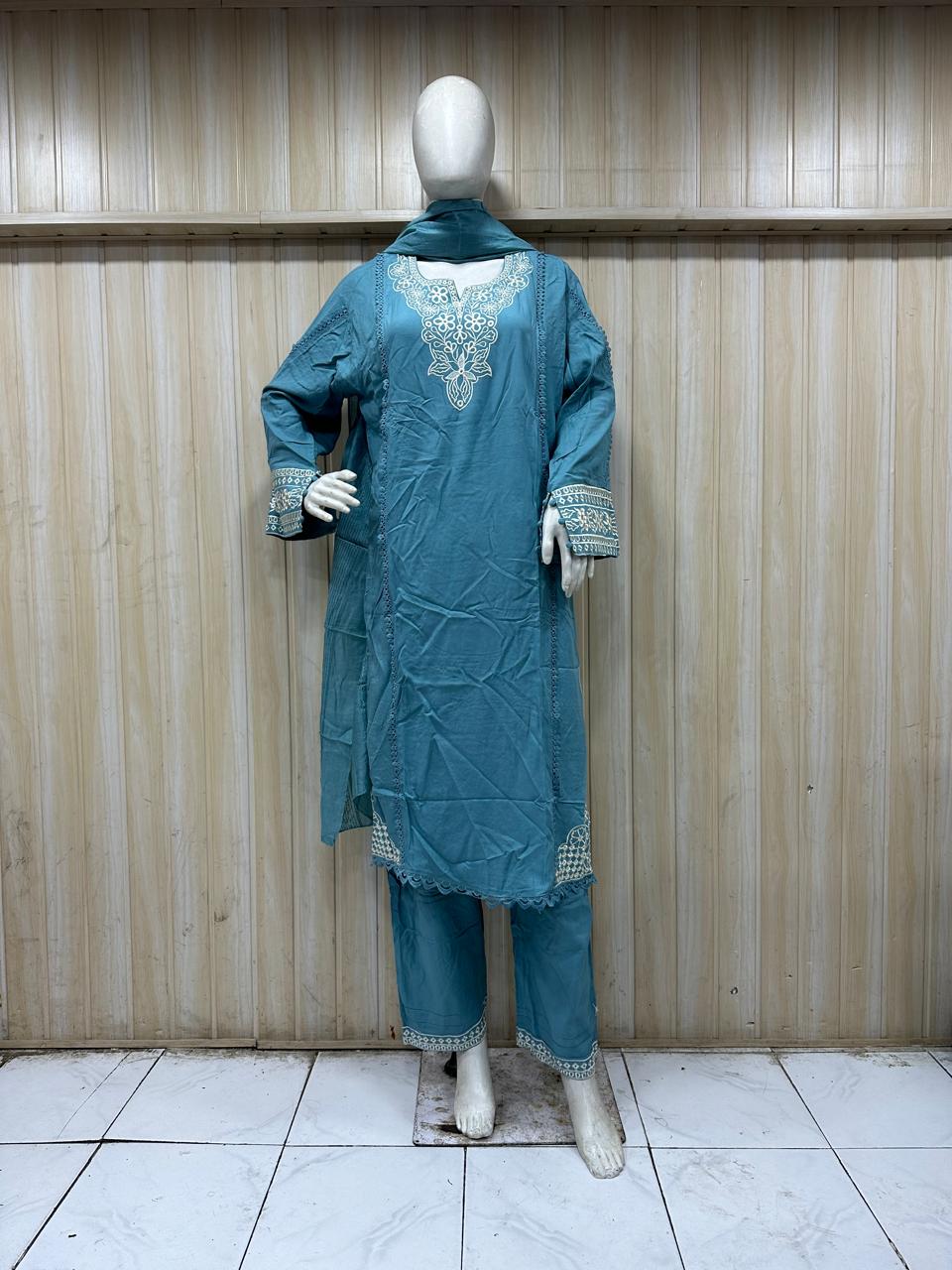 blue gold traditional outfit with matching dupatta on a mannequin against a striped