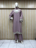 purple gold traditional outfit with matching dupatta on a mannequin against a striped
