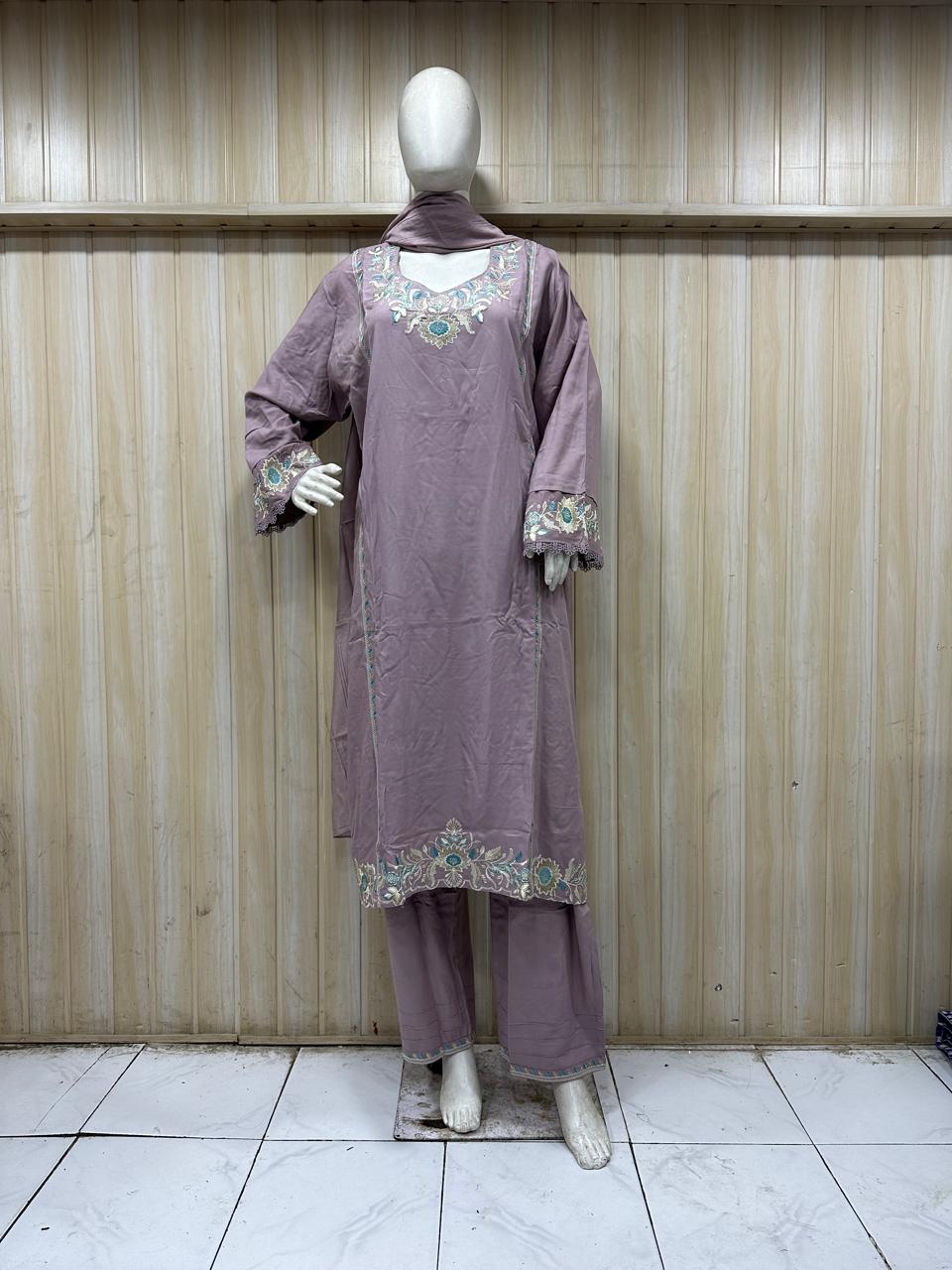 purple gold traditional outfit with matching dupatta on a mannequin against a striped