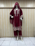 maroon gold traditional outfit with matching dupatta on a mannequin against a striped