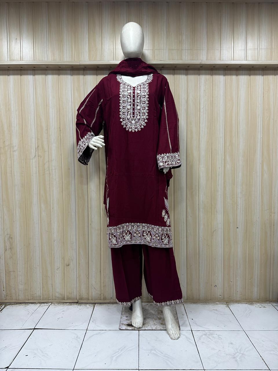 red gold traditional outfit with matching dupatta on a mannequin against a striped