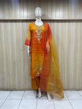 dark orang yellow gold traditional outfit with matching dupatta on a mannequin against a striped