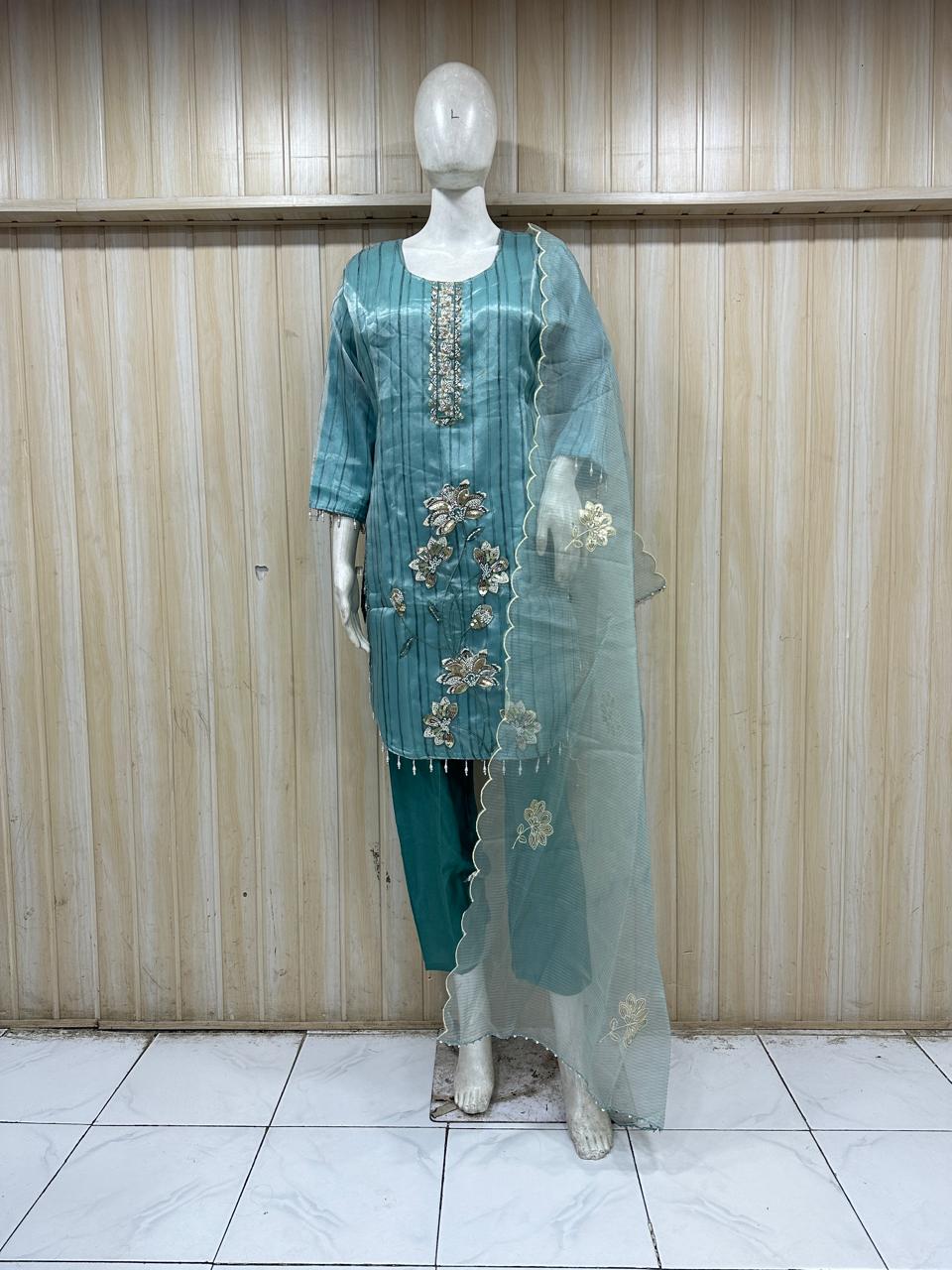 dark blue gold traditional outfit with matching dupatta on a mannequin against a striped