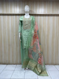 dark green gold traditional outfit with matching dupatta on a mannequin against a striped