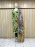 Mannequin wearing a green floral dress with a matching dupatta against a striped