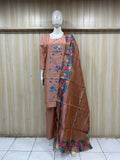 Mannequin wearing a orang floral dress with a matching dupatta against a striped
