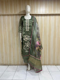 Green embroidered dress with a floral dupatta on a mannequin against a striped