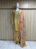 Mannequin wearing a traditional outfit with a gold dress and embroidered dupatta against a striped