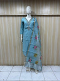 Mannequin wearing a blue traditional outfit with floral patterns against a striped