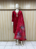 Mannequin wearing a maroon traditional outfit with floral patterns against a striped