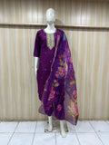purple embroidered outfit with a floral dupatta on a mannequin against a striped