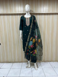 black embroidered outfit with a floral dupatta on a mannequin against a striped