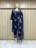 Mannequin wearing a navy blue traditional outfit with a pink dupatta against a striped