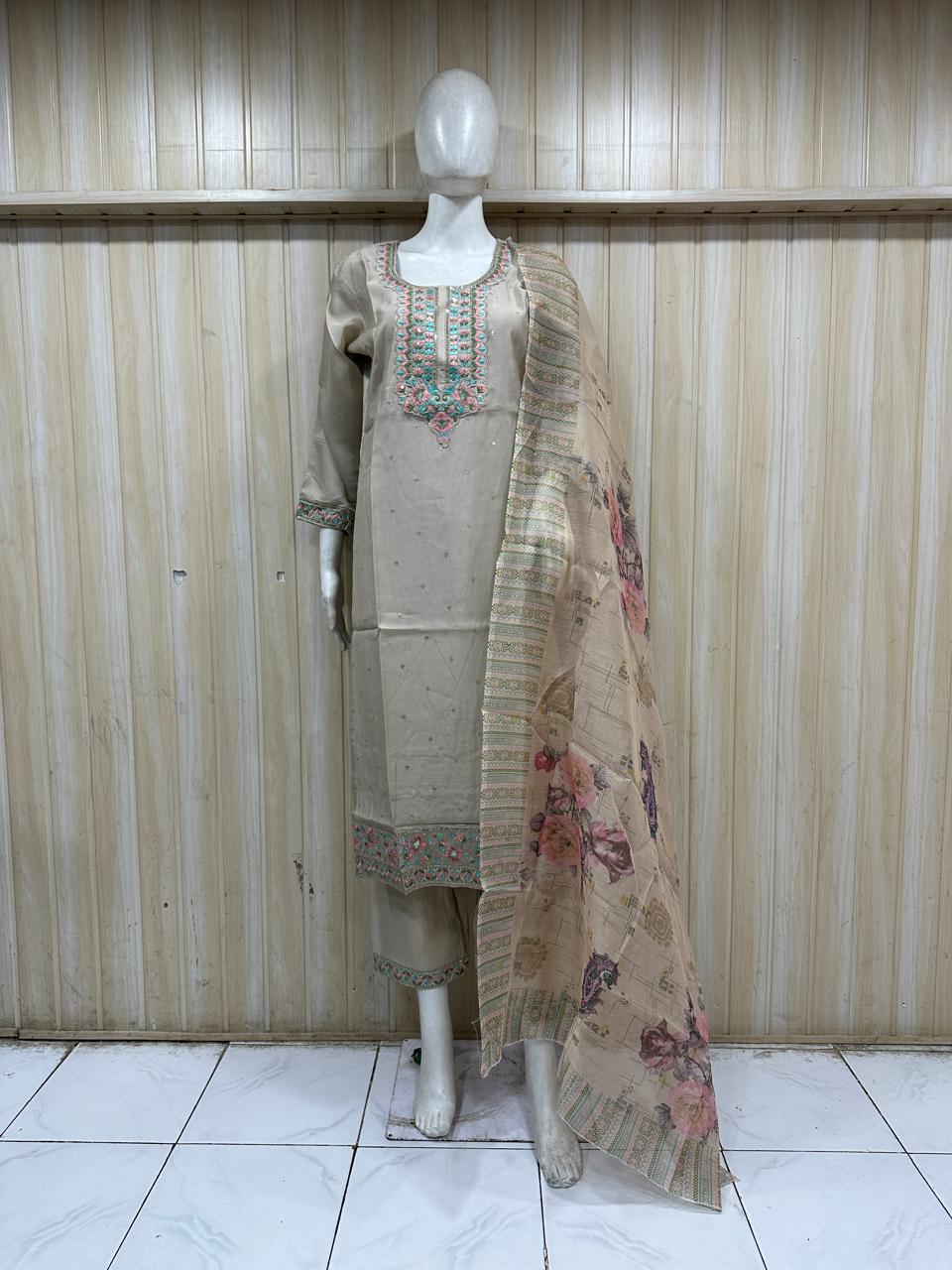 Mannequin wearing a beige kurta with floral dupatta against a striped