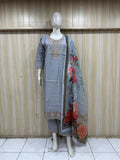 Mannequin wearing a grey traditional outfit with a saree against a wooden panel background