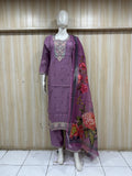 Mannequin wearing a purple traditional outfit with a saree against a wooden panel background