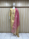 Mannequin wearing a yellow dress with pink dupatta against a striped