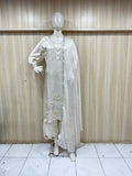 white embroidered traditional outfit on a mannequin against a striped