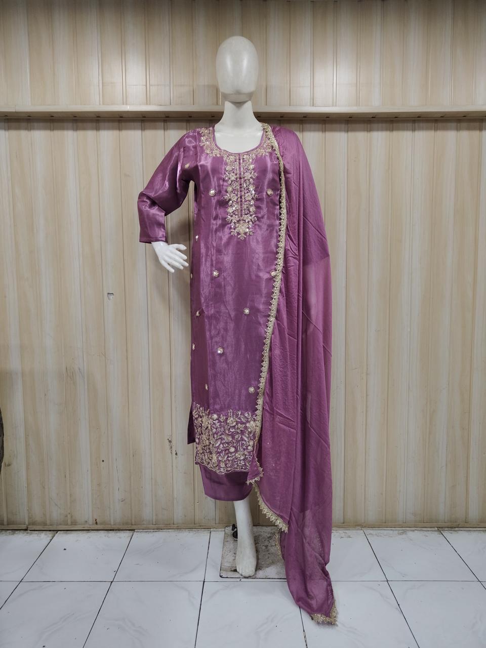 purple gold traditional outfit with gold embroidery on a mannequin against a striped