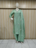 Mannequin wearing a light green embroidered outfit with a sheer dupatta against a wooden panel background.