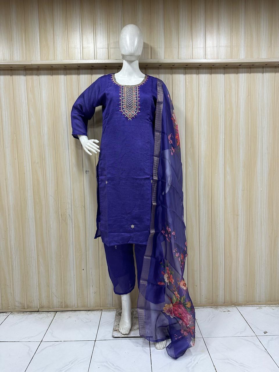 navy blue embroidered outfit on a mannequin against a striped