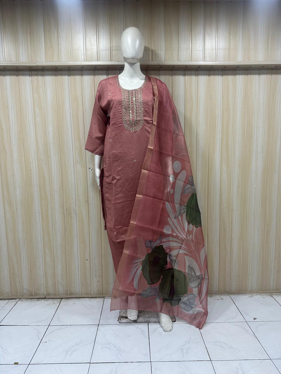 rose gold Purple traditional outfit with a dupatta on a mannequin against a striped