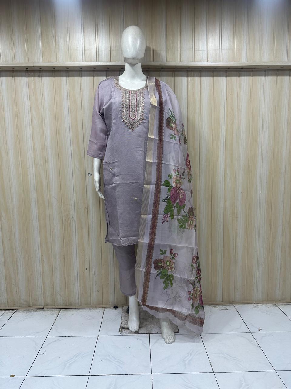 grey gold  traditional outfit with a dupatta on a mannequin against a striped