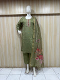 green gold traditional outfit with a dupatta on a mannequin against a striped